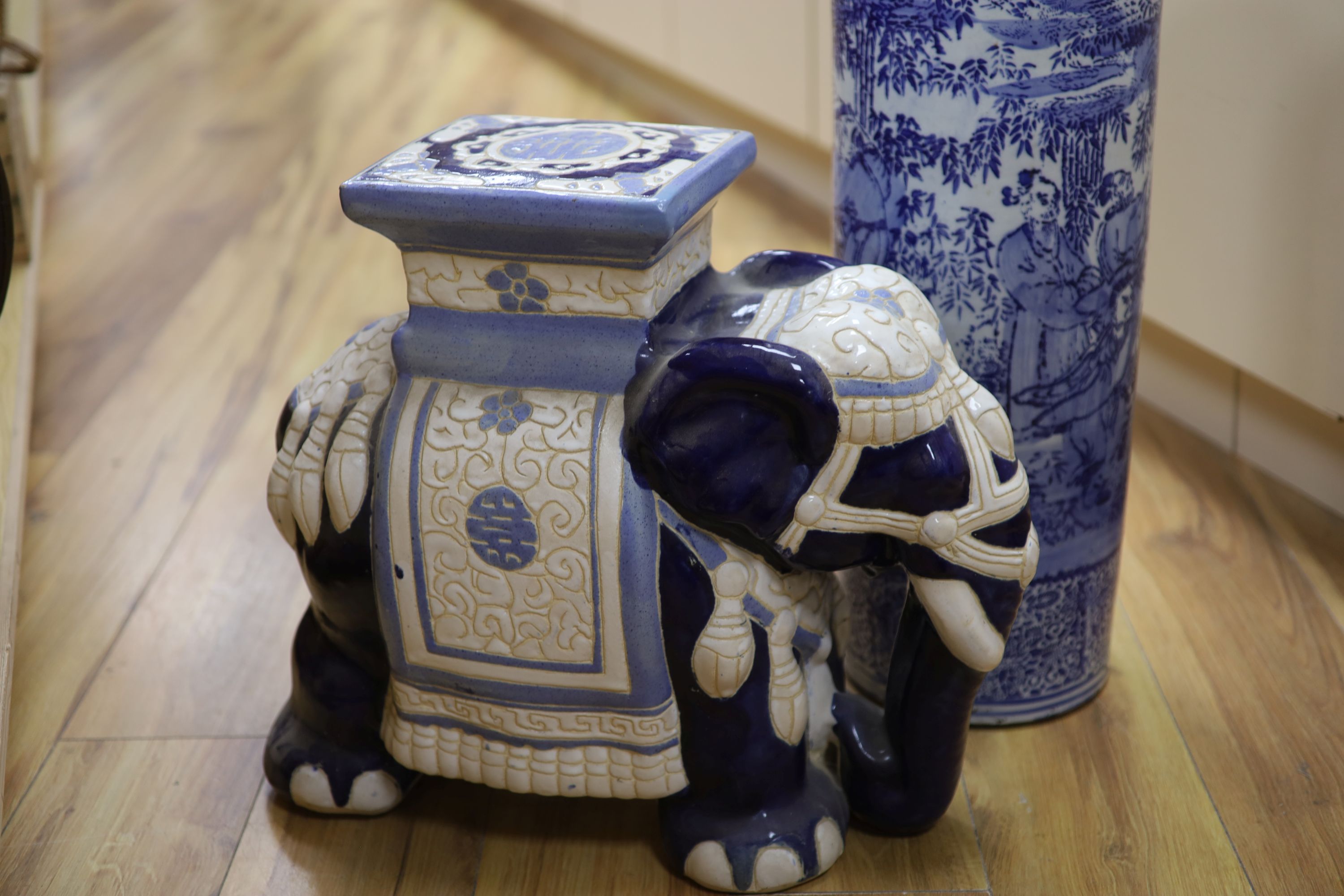 Two Chinese ceramic elephant garden seats and a blue and white stick stand, height 61cm